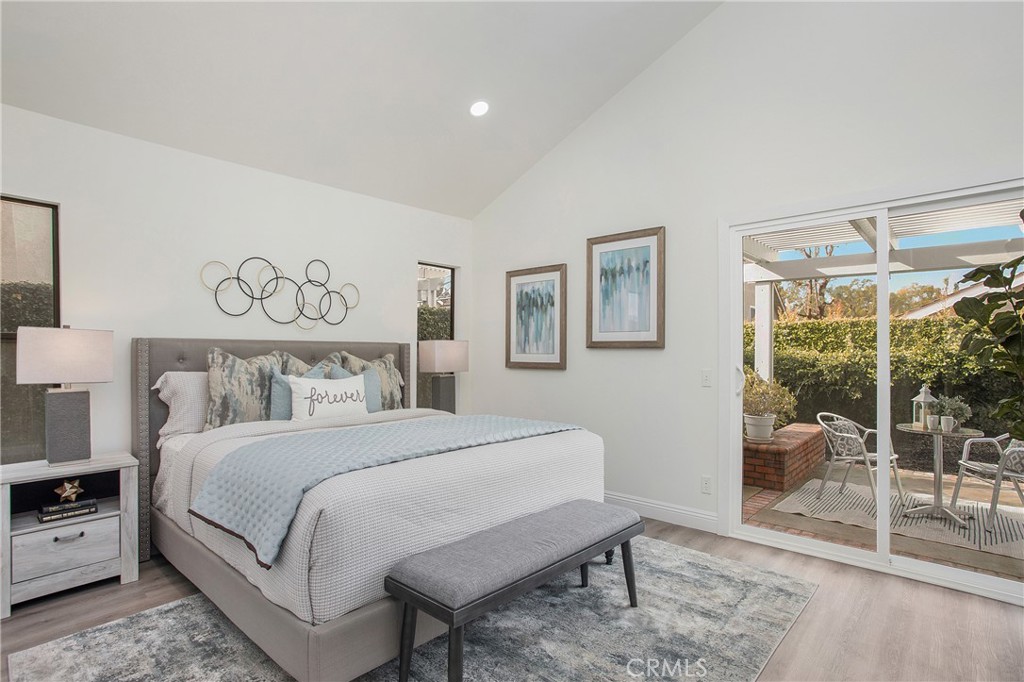 11 Ensueno Irvine, CA 92620 - Photo 21 of 36 a bedroom with a large bed and a chair