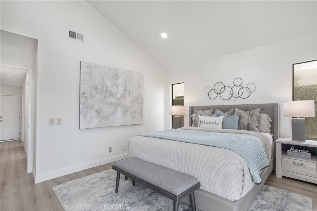 11 Ensueno Irvine, CA 92620 - Photo 23 of 36 a bedroom with a bed and a painting on the wall