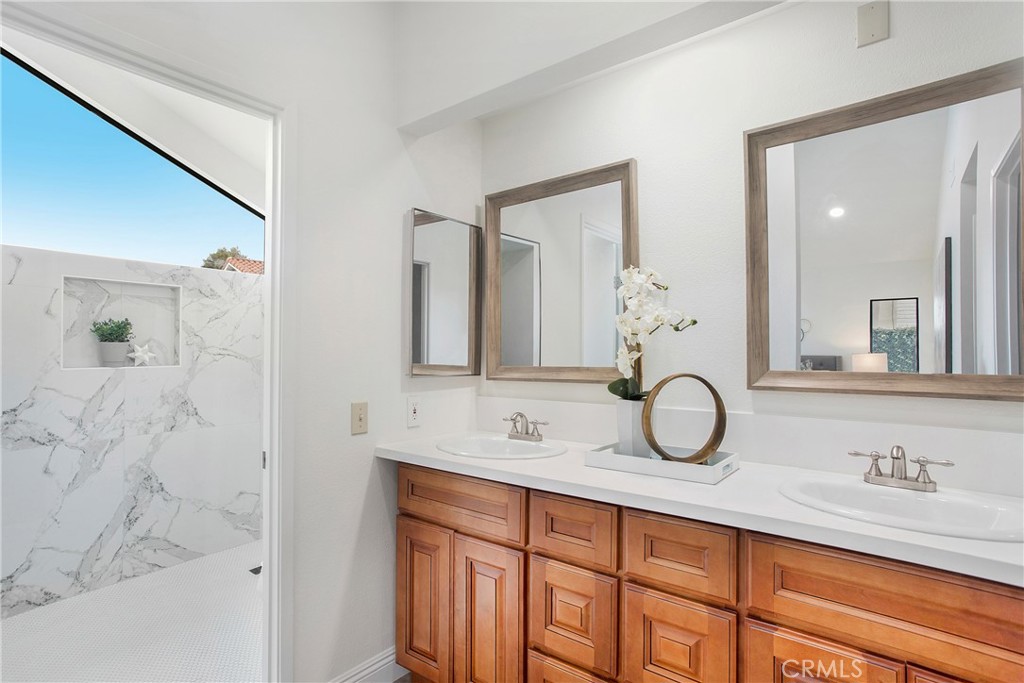 11 Ensueno Irvine, CA 92620 - Photo 24 of 36 a bathroom with a sink and a mirror