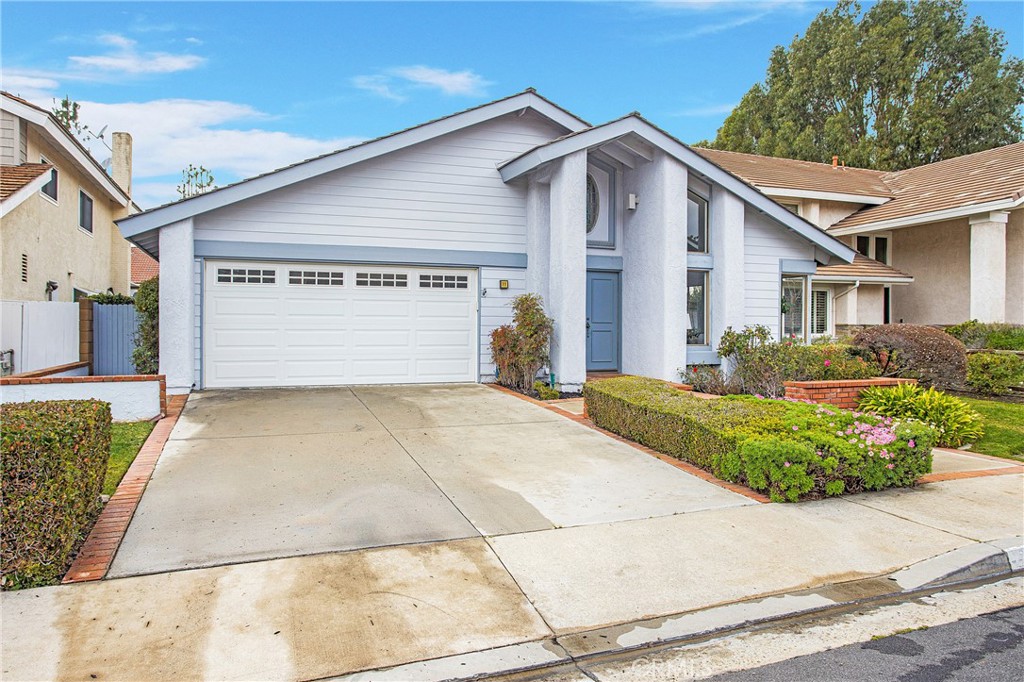11 Ensueno Irvine, CA 92620 - Photo 33 of 36 a front view of a house with a yard and garage