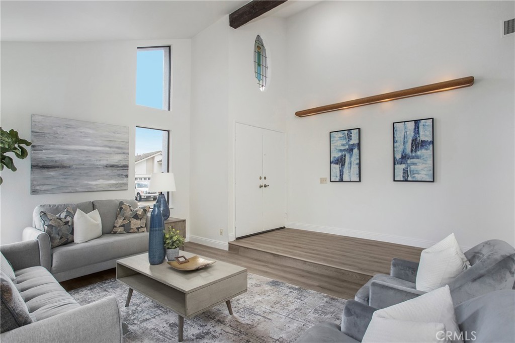 11 Ensueno Irvine, CA 92620 - Photo 4 of 36 a living room with furniture and a wooden floor