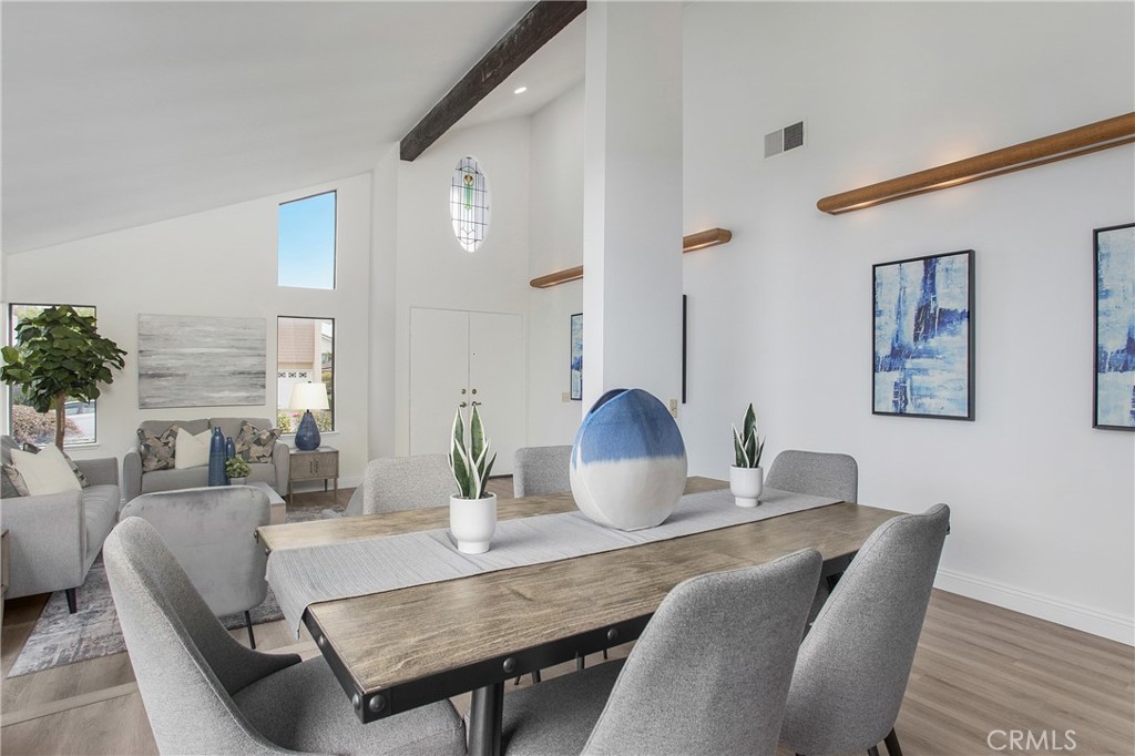 11 Ensueno Irvine, CA 92620 - Photo 7 of 36 a living room with furniture a large window and a table