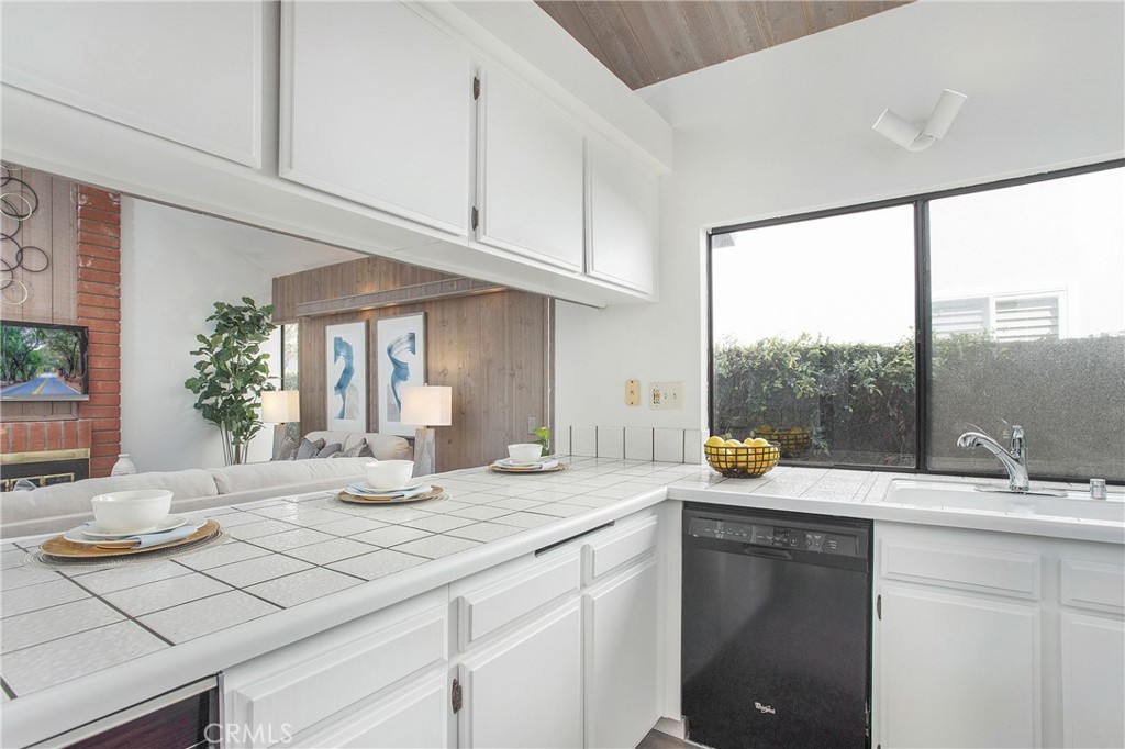 11 Ensueno Irvine, CA 92620 - Photo 10 of 36 a bathroom with a granite countertop sink and a large mirror
