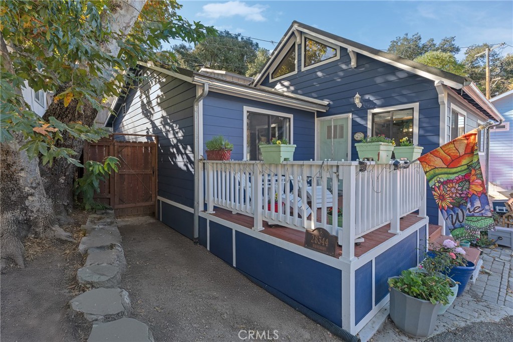 a view of a house with a yard and deck