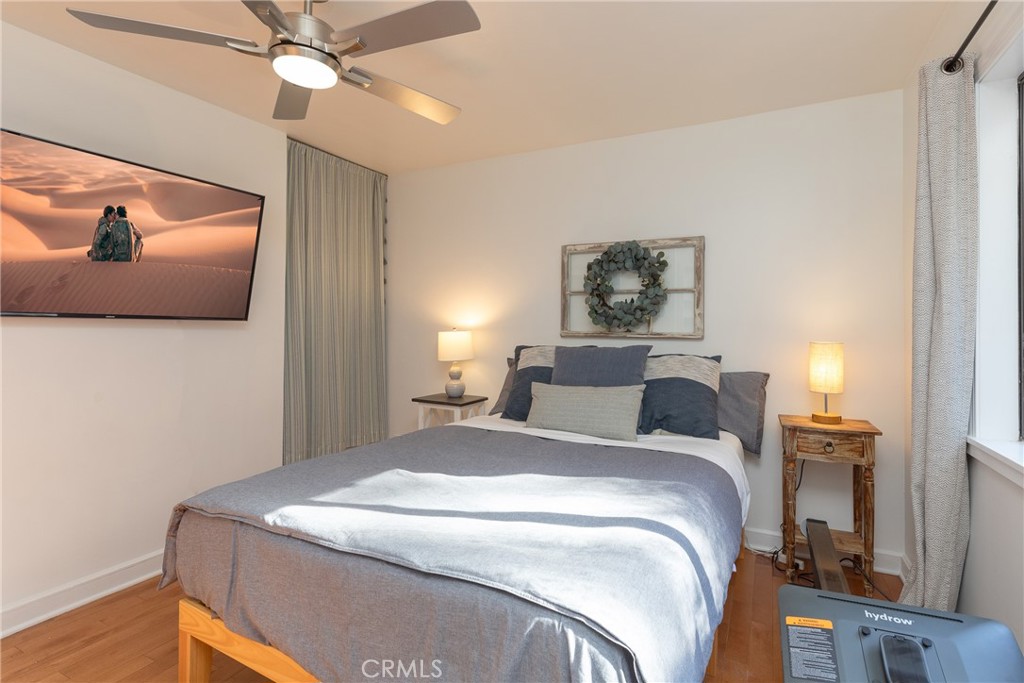 28344 Water Way Silverado, CA 92676 - Photo 20 of 34 a bedroom with a bed and a chandelier
