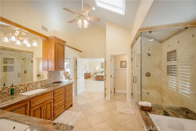 a view of walk in closet with clothes