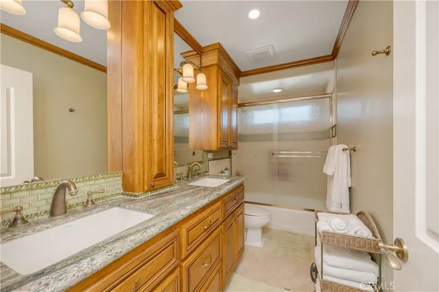 a bedroom with a bed and glass window