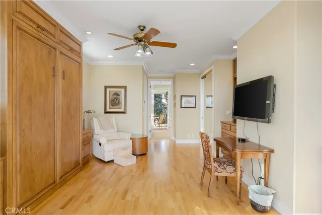 a view of a livingroom with furniture wooden floor closet and windows