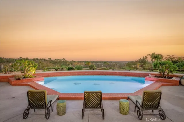 a view of swimming pool with outdoor seating