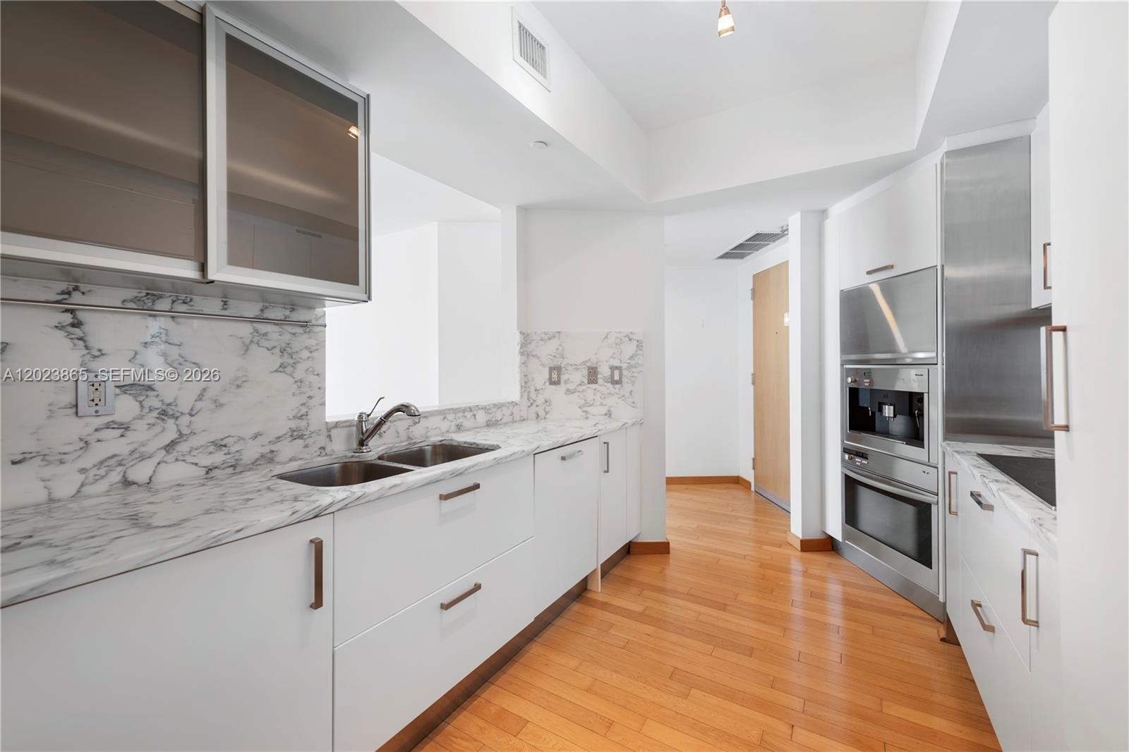450 Alton Road, Unit 3206 Miami Beach, FL 33139 - Photo 8 of 25 a kitchen with a sink stove and refrigerator