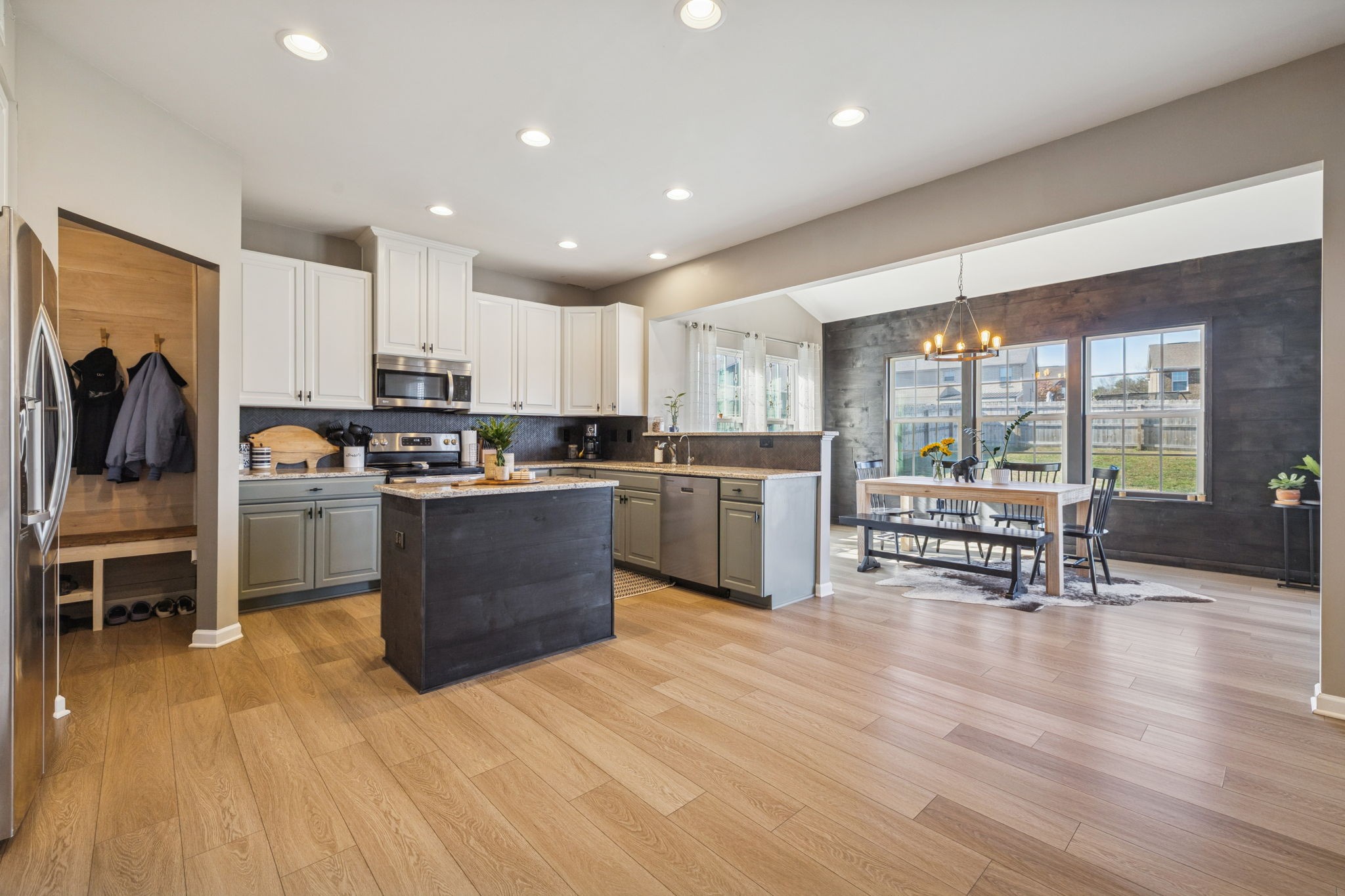 140 Hackney Lane Gallatin, TN 37066 - Photo 23 of 66 a kitchen with stainless steel appliances kitchen island granite countertop a stove top oven a sink a dining table and chairs