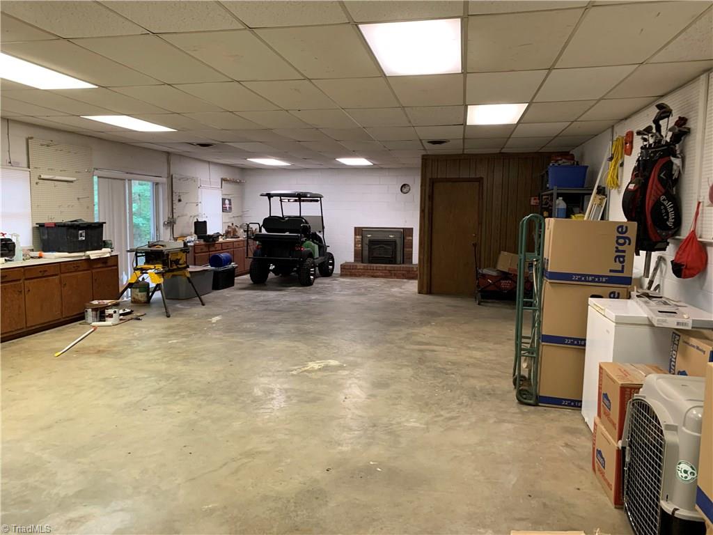 310 Paso Street Rural Hall, NC 27045 - Photo 12 of 30 kitchen leads to the ultimate man cave 24'x55' heated/cooled garage with FP/wood stove, just bring the toys