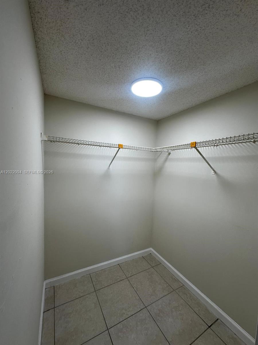 3400 Foxcroft Road, Unit 301 Miramar, FL 33025 - Photo 44 of 72 a view of a room with racks on the wall