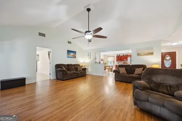 a living room with furniture and a ceiling fan