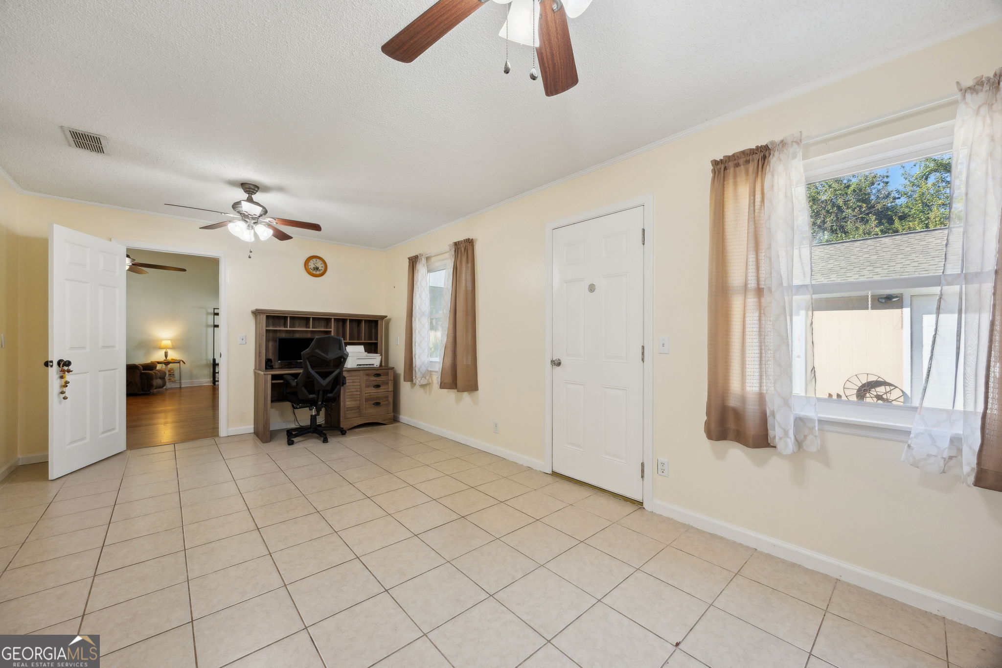 381 Powderhorn Road St. Marys, GA 31558 - Photo 15 of 37 a view of a livingroom with a fireplace a ceiling fan and window
