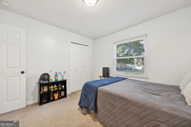 a bedroom with a bed and a window