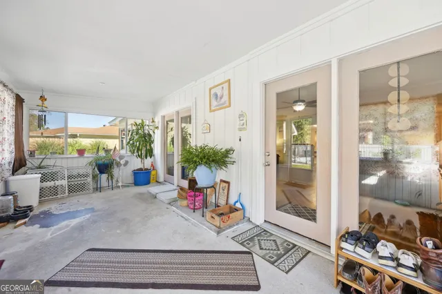 a living room with furniture and a floor to ceiling window