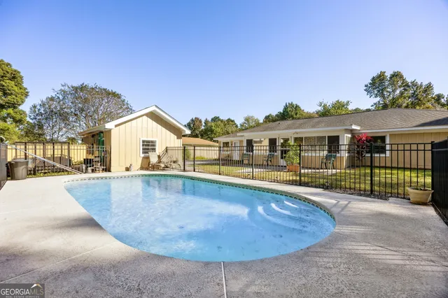 a view of a house with swimming pool and porch