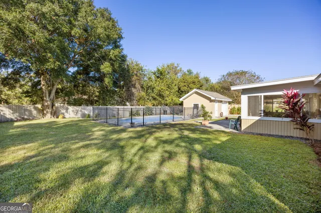a view of a house with a yard and sitting area
