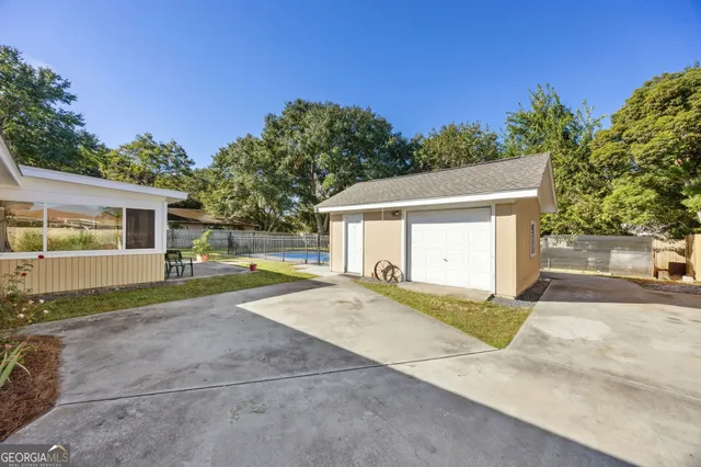 a view of a house with backyard and a tree