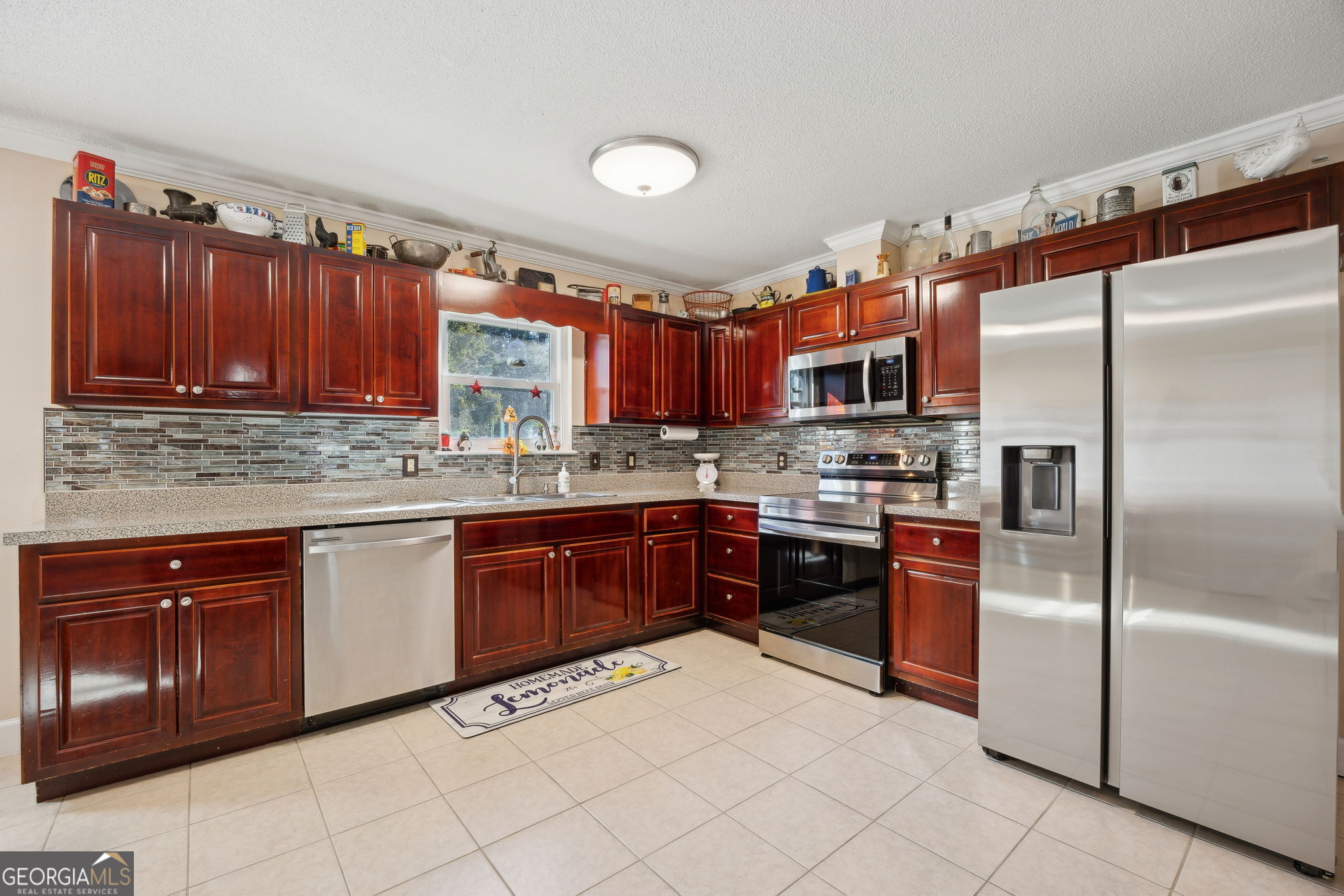 381 Powderhorn Road St. Marys, GA 31558 - Photo 8 of 37 a kitchen with stainless steel appliances granite countertop a refrigerator and a sink