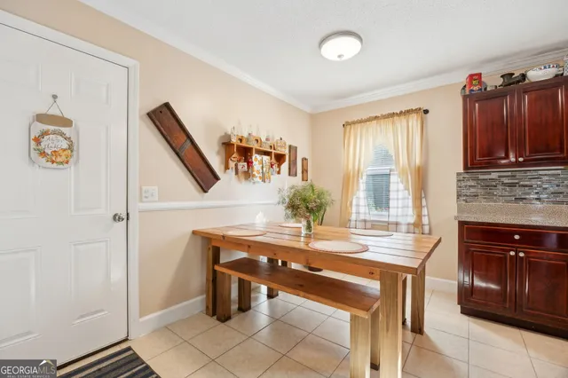 a room with table chairs and entryway