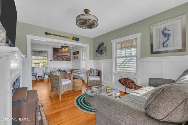 a living room with furniture a rug and a window
