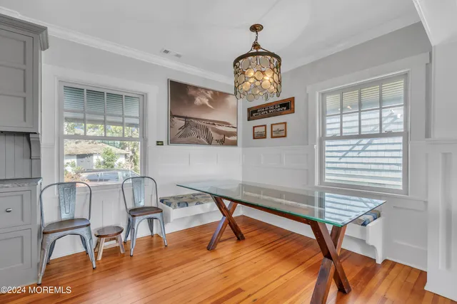 a view of a livingroom with furniture window and wooden floor