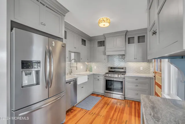 a kitchen with stainless steel appliances granite countertop a refrigerator stove and sink