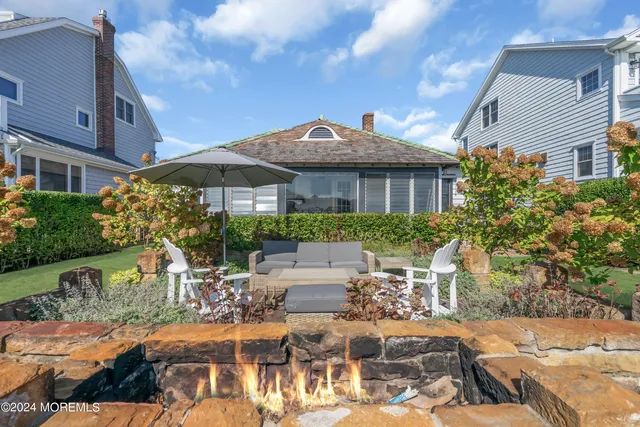 a view of a patio with table and chairs under an umbrella