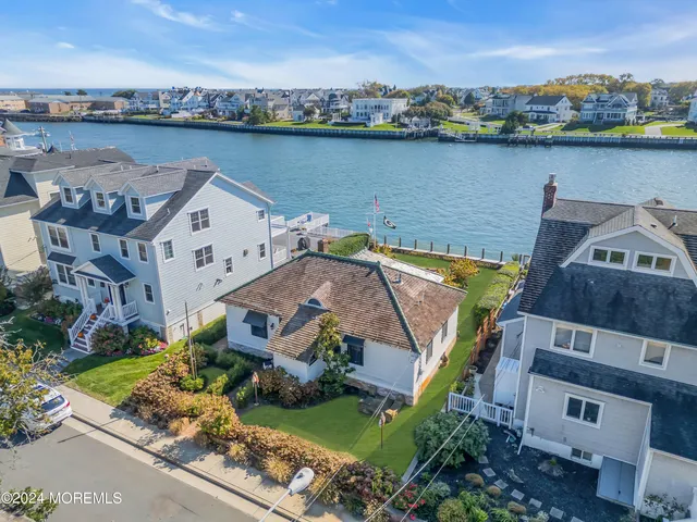 an aerial view of a house with a lake view