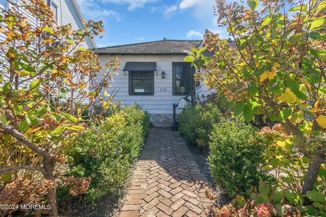 a front view of a house with lots of green space