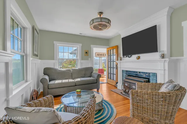 a living room with furniture a flat screen tv and a fireplace
