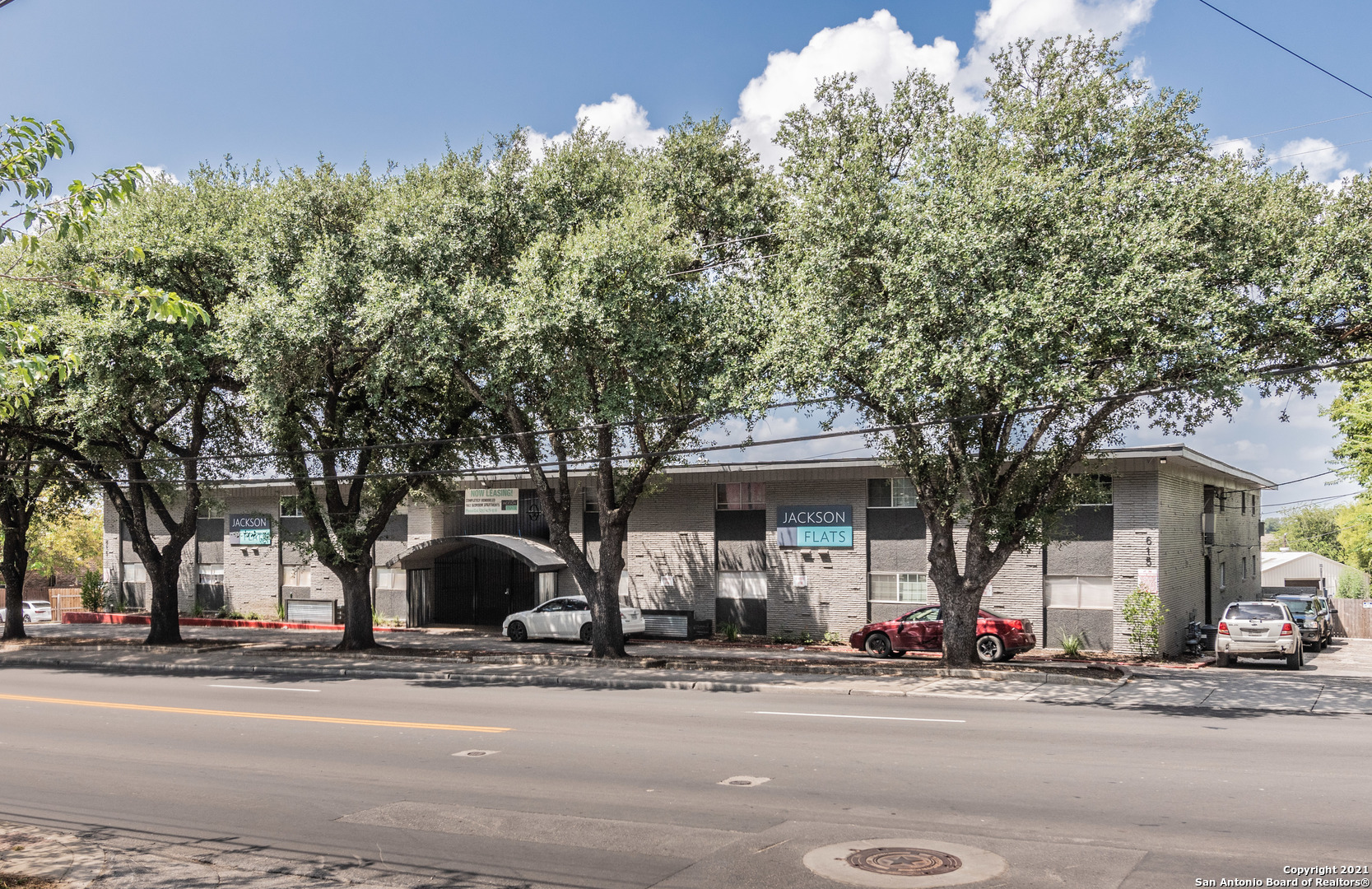 615 Vance Jackson Road, Unit 101 San Antonio, TX 78201 - Photo 1 of 10 a front view of a house with a yard and garage