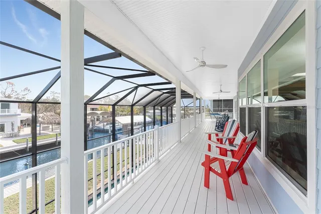 a bedroom with a bed a dresser and wooden floor