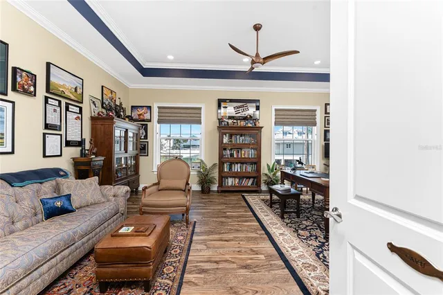 a dining hall with stainless steel appliances granite countertop a stove a sink dishwasher a dining table and chairs with wooden floor