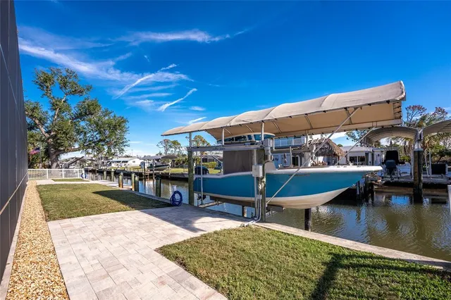 a view of a hallway with wooden floor and windows