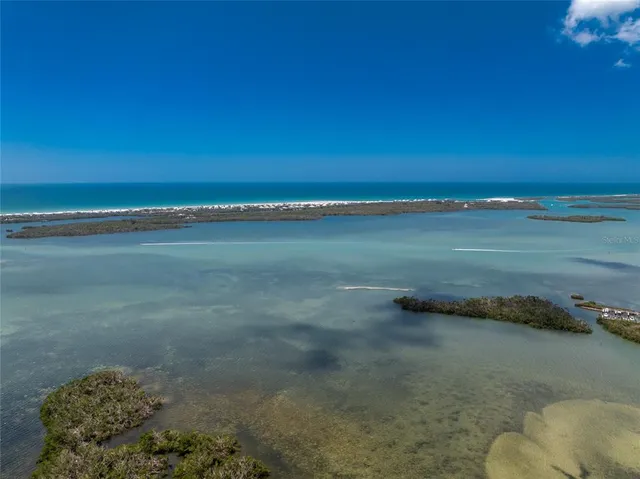 a living room with furniture a flat screen tv and kitchen view