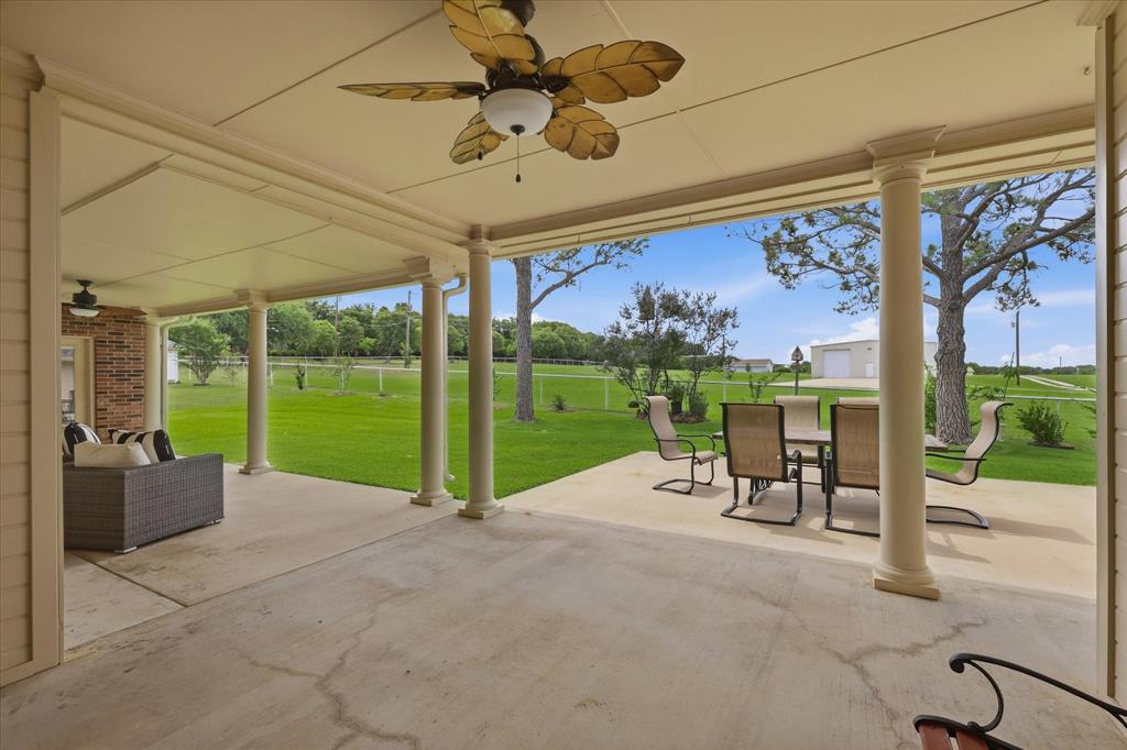 6955 Hawk Road Flower Mound, TX 75022 - Photo 31 of 40 Expansive covered patio featuring a concrete surface, multiple support columns, and an integrated ceiling fan