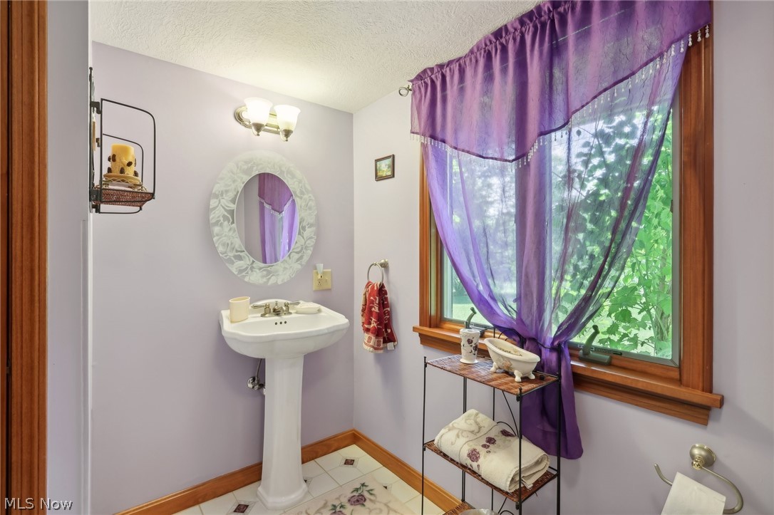 1534 West Comet Road Clinton, OH 44216 - Photo 42 of 43 Full bath on lower level with tile floors and a textured ceiling