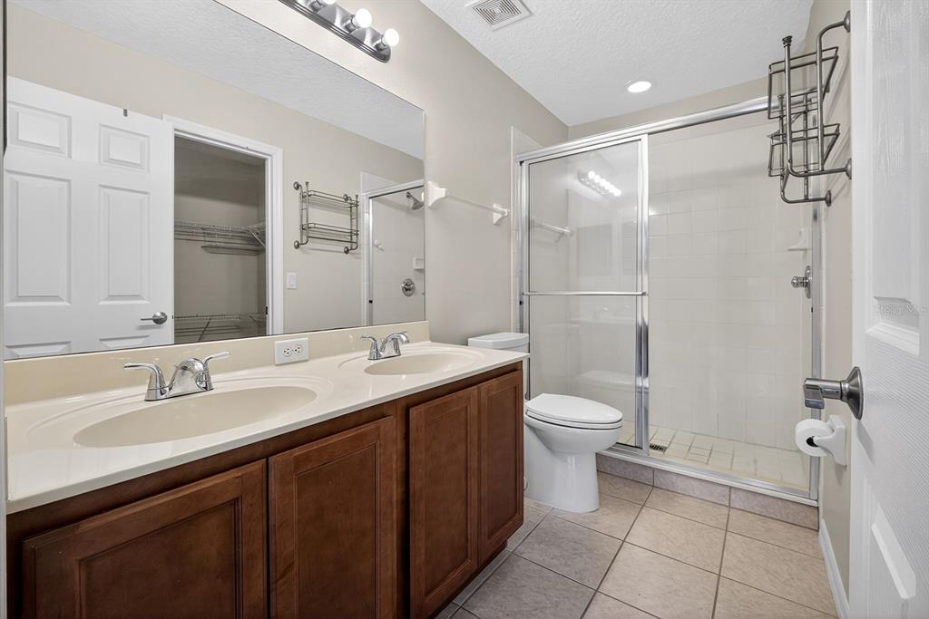 14239 Avenue Of The Groves Winter Garden, FL 34787 - Photo 12 of 54 a bathroom with a double vanity sink toilet and shower