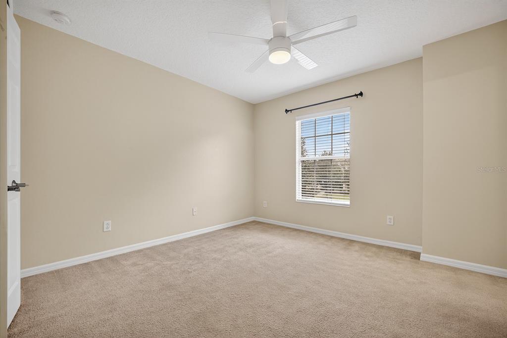 14239 Avenue Of The Groves Winter Garden, FL 34787 - Photo 17 of 54 an empty room with a window and a fan