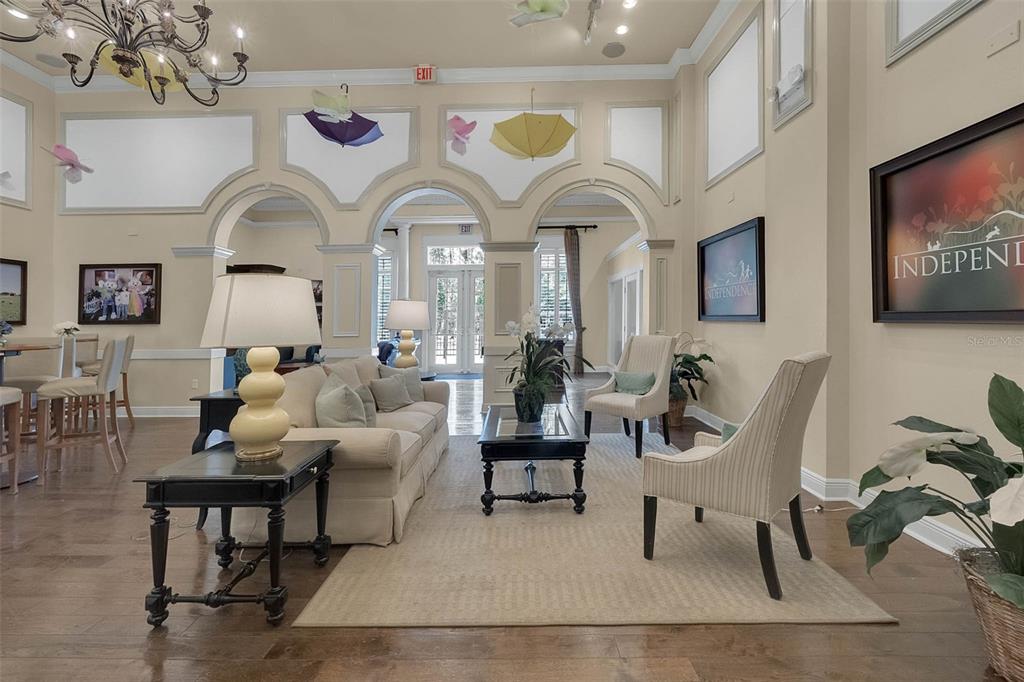 14239 Avenue Of The Groves Winter Garden, FL 34787 - Photo 34 of 54 a living room with furniture a chandelier and a potted plant