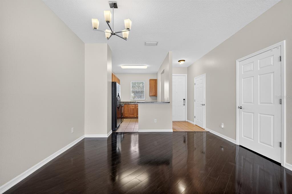14239 Avenue Of The Groves Winter Garden, FL 34787 - Photo 4 of 54 a view of a kitchen with wooden floor and a chandelier