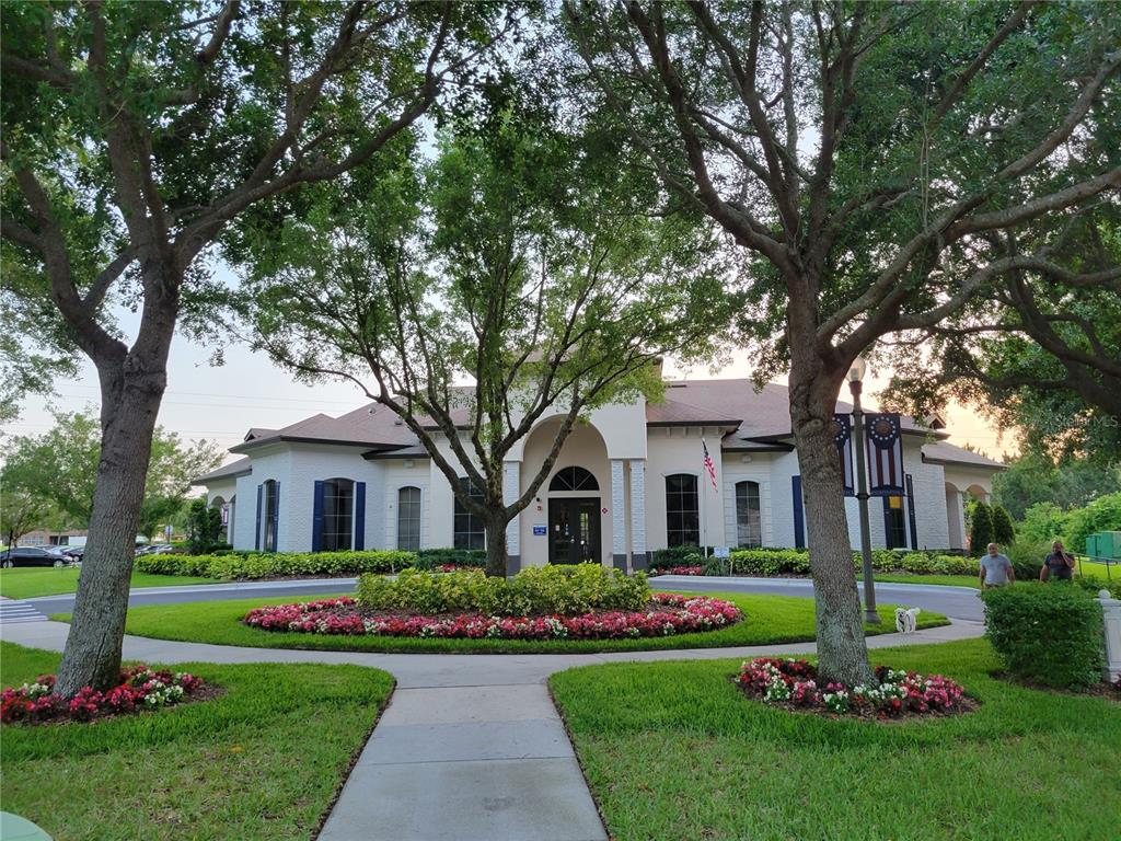 14239 Avenue Of The Groves Winter Garden, FL 34787 - Photo 46 of 54 a front view of a house with a garden and trees