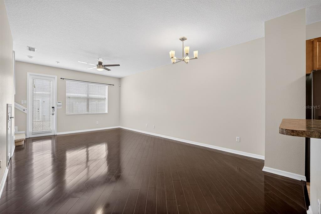 14239 Avenue Of The Groves Winter Garden, FL 34787 - Photo 5 of 54 wooden floor in an empty room with a window