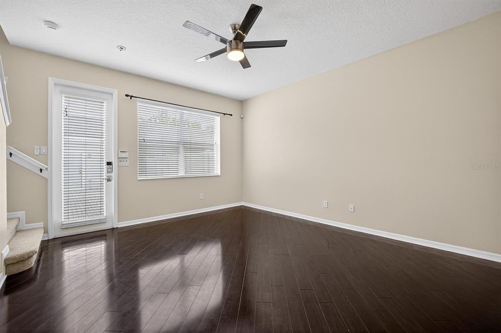 14239 Avenue Of The Groves Winter Garden, FL 34787 - Photo 6 of 54 wooden floor in an empty room with a window