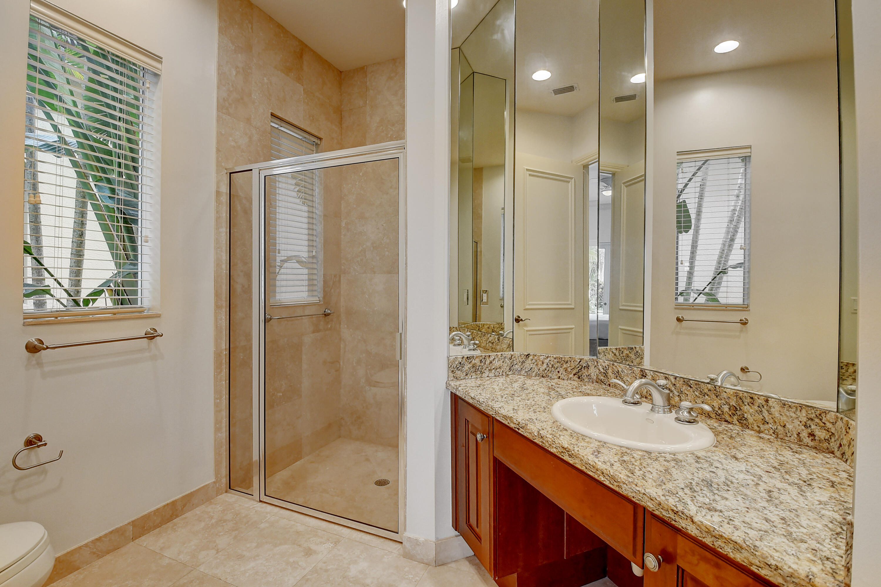 17698 Middlebrook Way Boca Raton, FL 33496 - Photo 21 of 68 a bathroom with a granite countertop sink a mirror and a shower