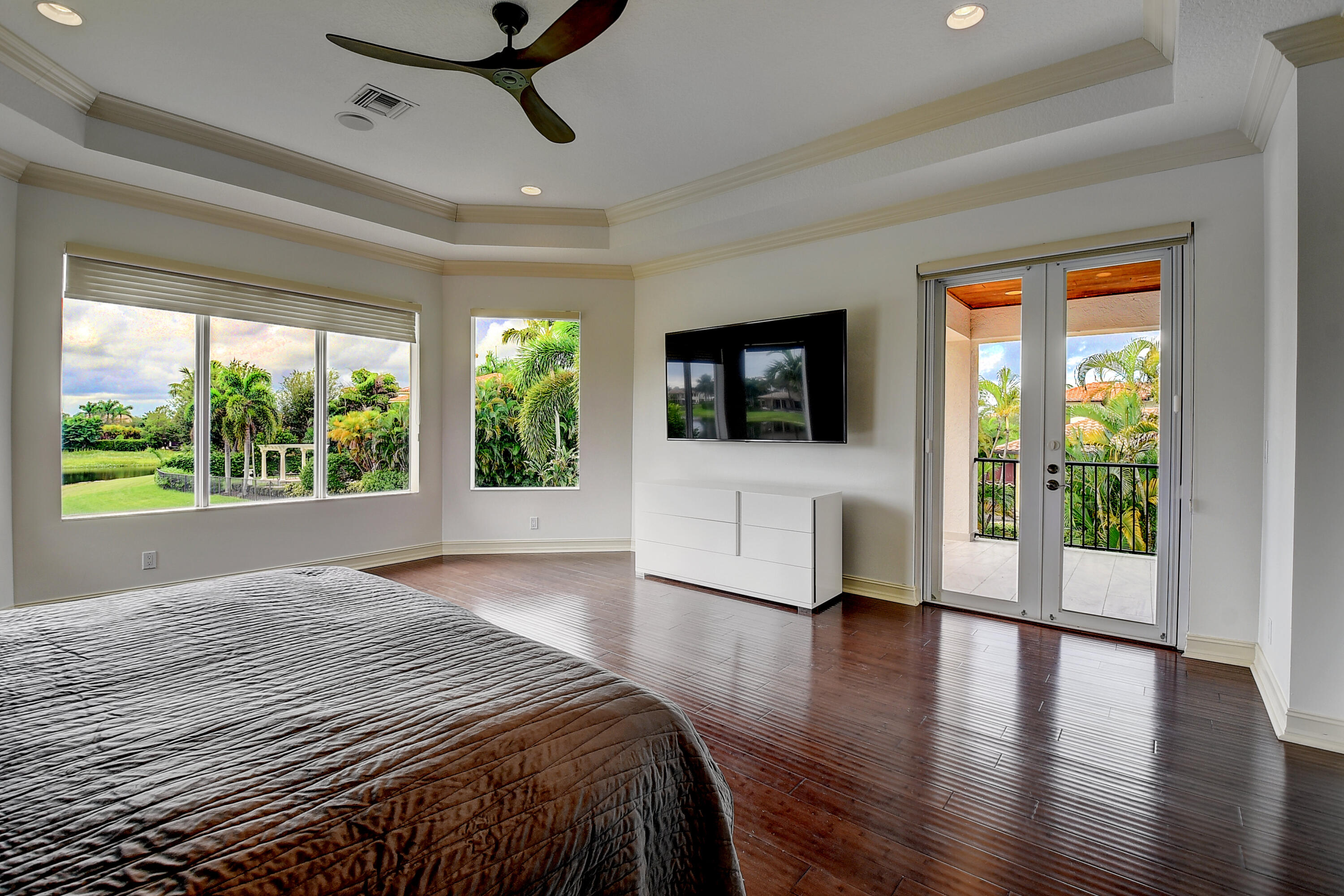 17698 Middlebrook Way Boca Raton, FL 33496 - Photo 28 of 68 a spacious bedroom with a large bed and a wooden floor