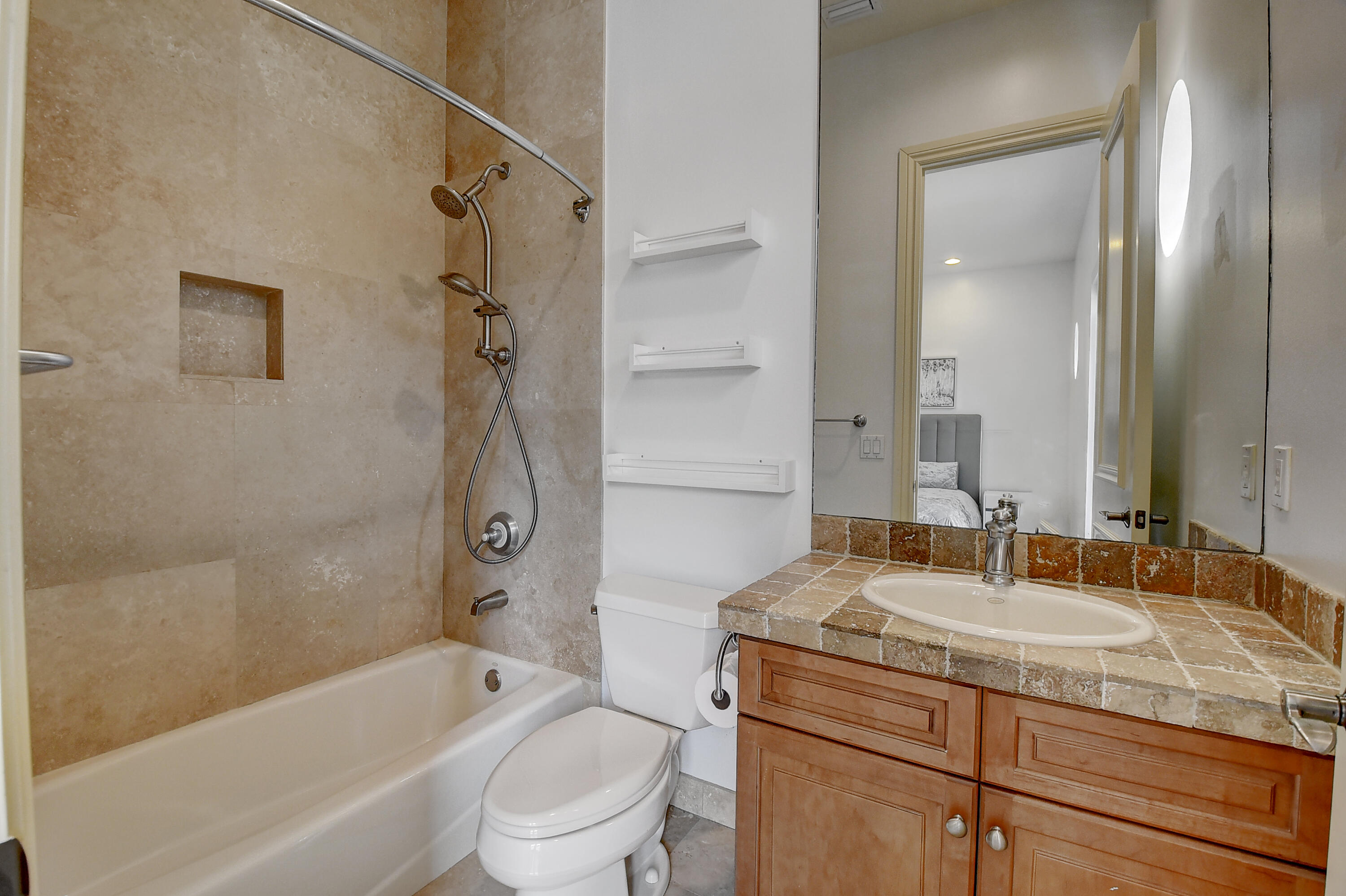 17698 Middlebrook Way Boca Raton, FL 33496 - Photo 38 of 68 a bathroom with a granite countertop sink a toilet and shower